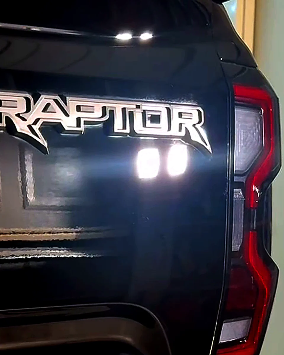 The same tailgate after a two-step paint correction and ceramic coating: a clear, mirror-flat reflection