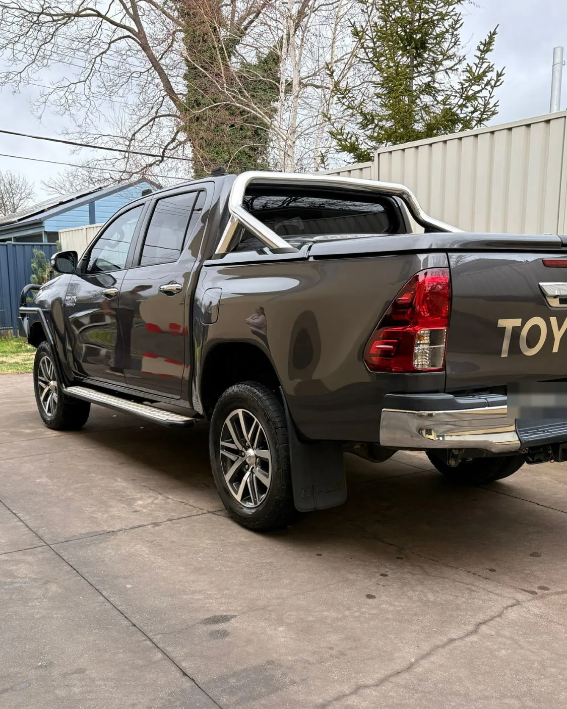 Grey Toyota HiLux SR5 dual cab, washed and dried, on a driveway