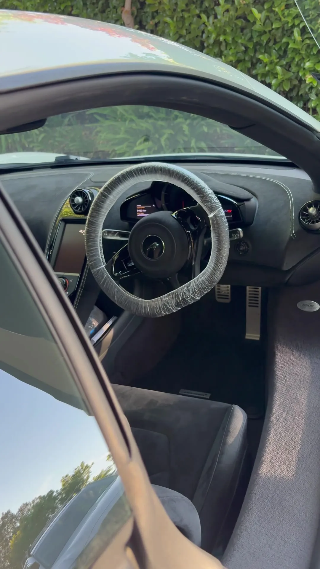 Inside a McLaren after an interior detail: steering wheel, seats and carbon trim
