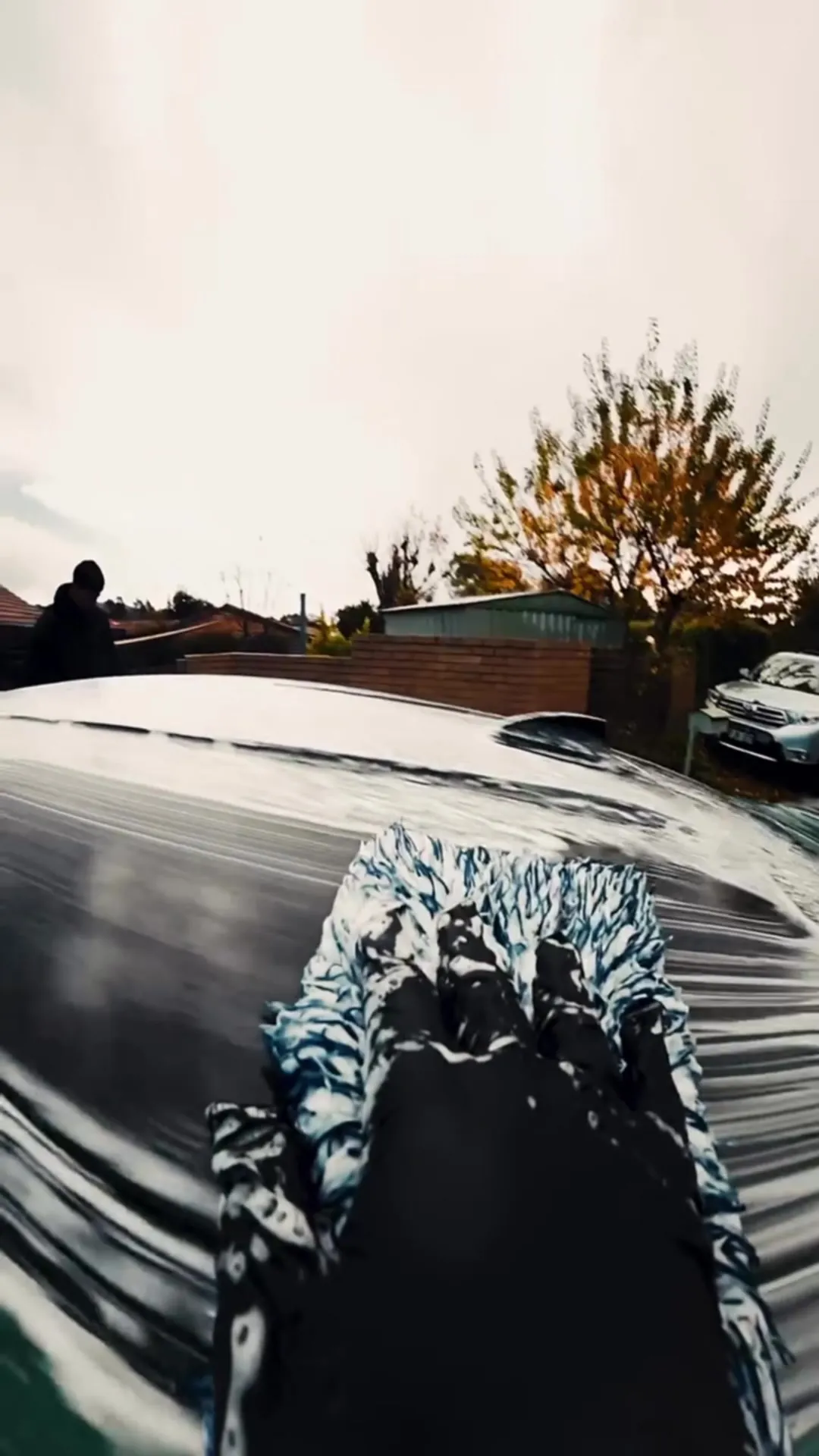 A wash mitt on the bonnet of a BMW M4 during a maintenance wash