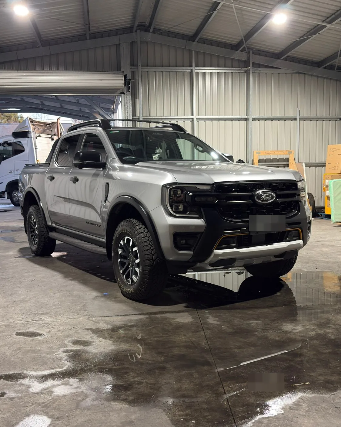 Silver Ford Ranger Wildtrak dual cab, finished, in a workshop shed
